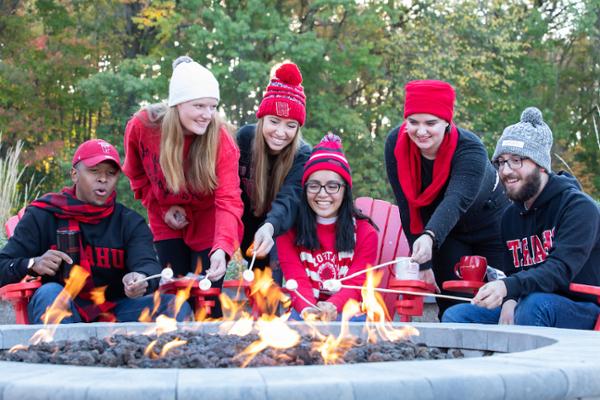 students making s'mores around the Poe fire pit